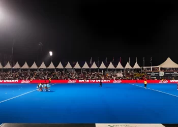 Image: Rajgir Hockey Stadium under lights, packed with fans or in dramatic twilight. Asia cup 2025
