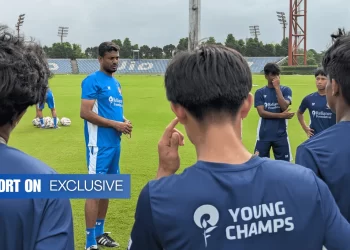Chembakath holding a football, RFYC training pitch behind